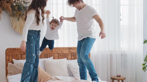 Young Loving Caucasian Parents Playing at Home Having Fun Enjoying Game Time with Little Daughter