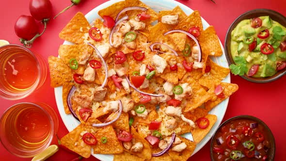 A Plate of Delicious Tortilla Nachos with Melted Cheese Sauce, Grilled Chicken