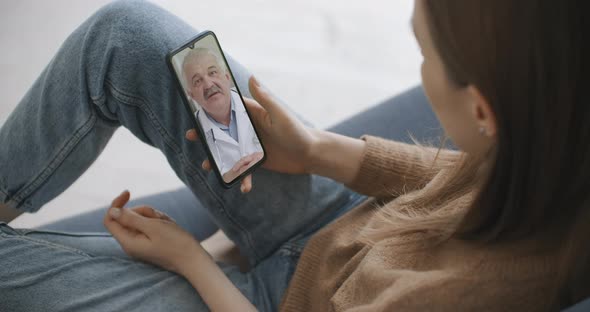 Woman Checks Possible Symptoms with Professional Physician, Using Online Video Chat. Young Girl Sick