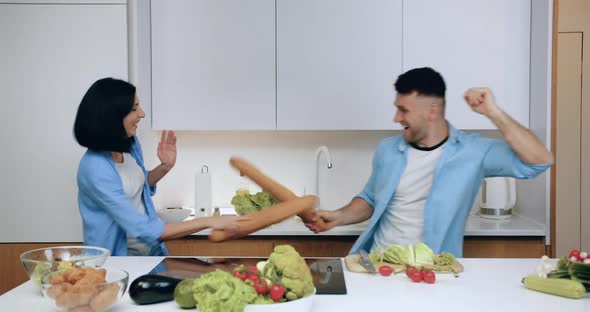 Married Couple Having Fun on Modern Kitchen During Preparing Dinner