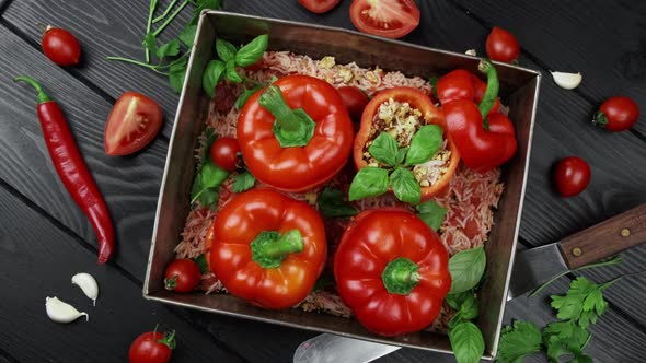 Stuffed Red Peppers with Rice Onion on Black Stone Background