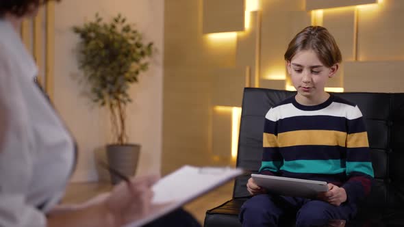 Psychologist Using Drawings on Tablet to Test Kid