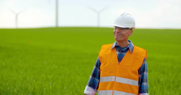 Male Engineer Working While Holding Blueprint