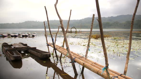 Panoramic View on Morning Mountain Lake with Bamboo Pier and Wooden Fisherman Boats