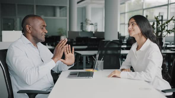 African Adult 50s Boss Businessman Recruiter Banker Talking to Arabic Female Candidate Young Trainee