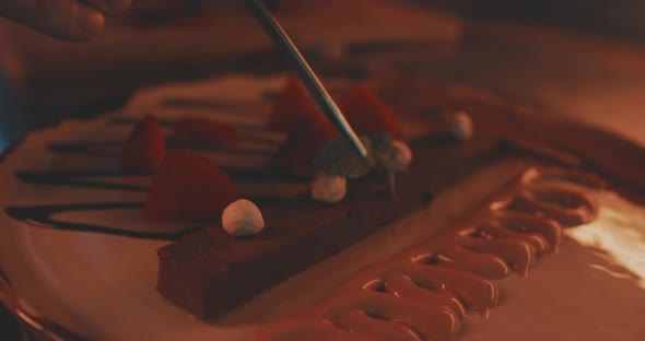 Professional plating of a dessert with mint leaf