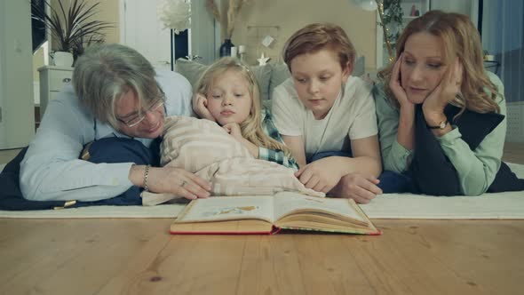 Grandparents Are Reading a Book with Their Grandchildren