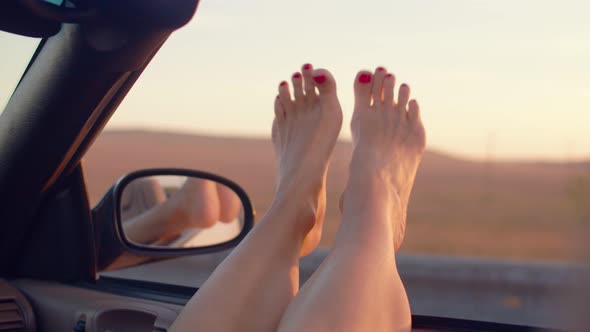 View of Beautiful Womans Legs Inside a Cabriolet During a Road Trip - Young Girl Having Fun
