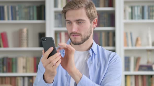 Portrait of Man Celebrating on Smartphone