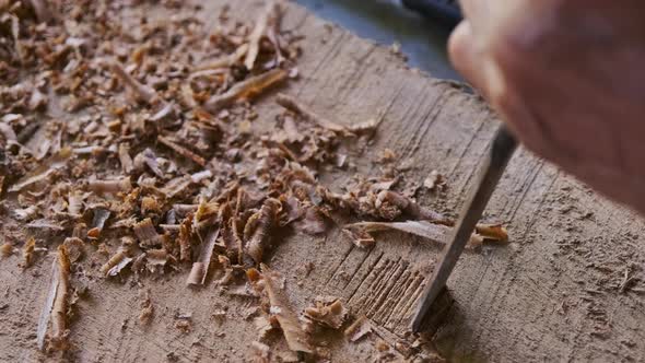 Local man using chisel making traditional handicrafts.