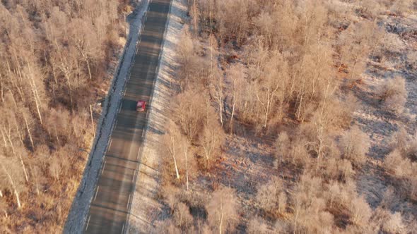 Drone Over Car On Road Towards Fjord