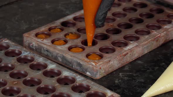 Chocolatier Preparing Handmade Cream Filled Chocolate Candy