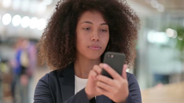 Young African Businesswoman Using Smartphone