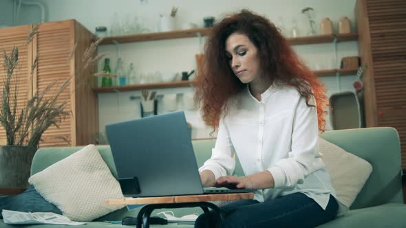 Lockdown Concept, Coronavirus Pandemic. A Woman Is Working From Home and Drinking Coffee