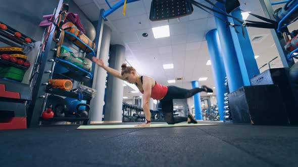 Fit woman exercising indoors. Young woman exercising in fitness class