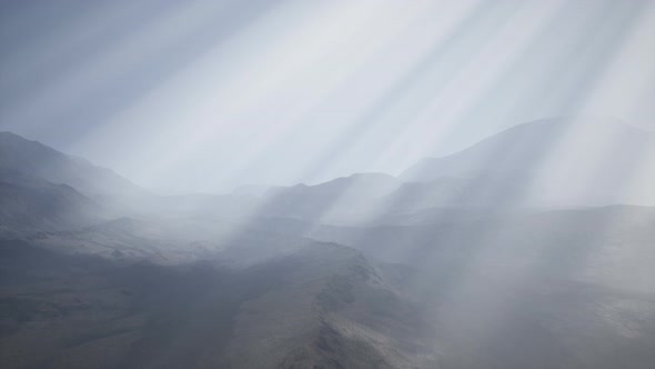 Sun Rays Against the Backdrop of the Mountains