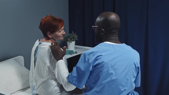 Nurse Patting Patient on Shoulder