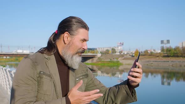 Middleaged Bearded Man Making an Online Video Call