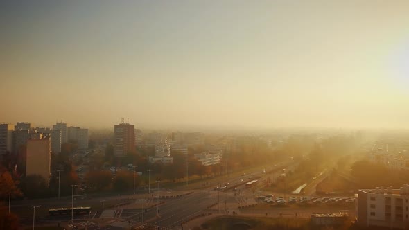 Beautiful cinematic aerial shot of misty sunrise in foggy town in autumn