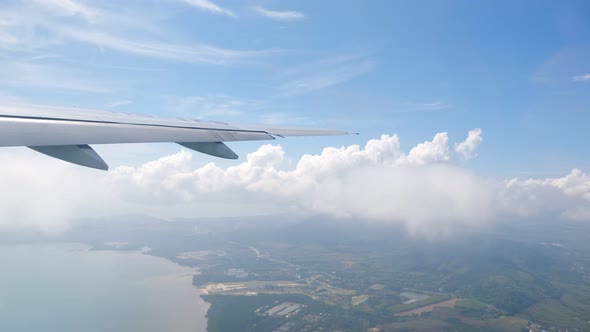 Wing of an Airplane Flying Above the Clouds