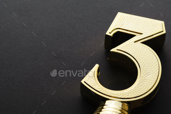 e of a textured number three over a dark grey background with copy space