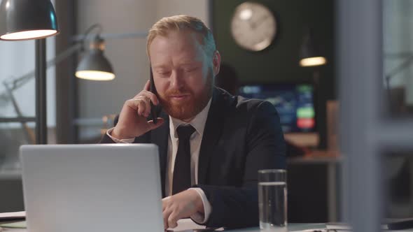 Businessman Talking on Mobile Phone in Office