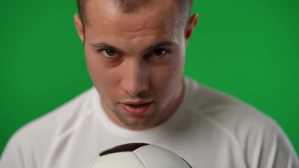 Front View Closeup of Serious Confident Sportsman with Football Ball Posing at Chromakey Background