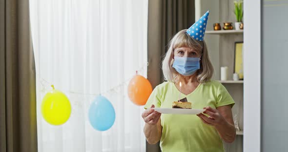 Senior Woman Celebrating a Special Occasion or Holiday at Home Alone Taking Off Her Protective Face