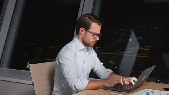 Young caucasian man professional using computer sitting at the desk