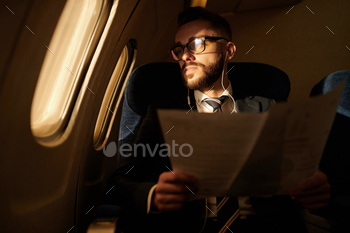  in window while flying by first class plane at night, copy space