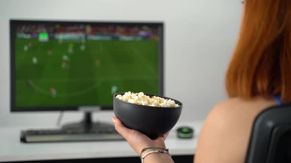 Woman Eating Popcorn While Watching Football Match 4K