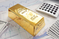 Gold bullion bar on a stocks and shares chart - PhotoDune Item for Sale