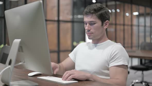 Positive Relaxing Man Sitting at Work