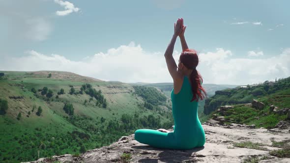 Athletic Girl Practices Yoga in Lotus Position Beautiful Mountain Landscape