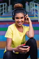 Pretty young black african american woman listening to music wit - PhotoDune Item for Sale