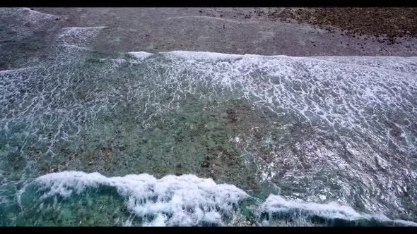 Aerial drone shot nature of tropical island beach lifestyle by blue lagoon with white sandy backgrou