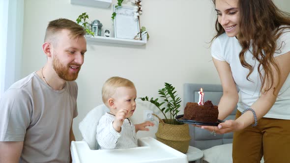 Happy Family Having First Birthday Party of Baby Boy at Home