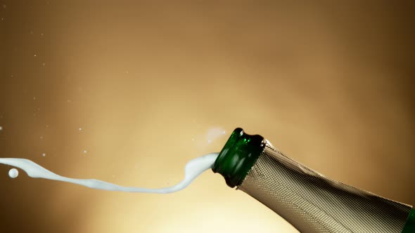 Super Slow Motion Shot of Champagne Explosion on Golden Luxury Background