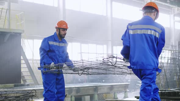 Workers laying iron armature to forms