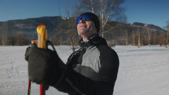 Smiling Cross Country Skier Holding Ski Poles