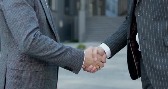 Close up of the Hands of Top managers in Business Suits Shake Hands With Each Other