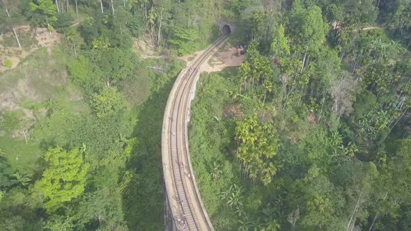 People Walk Along Old Demodara Bridge to Tunnel in Jungle