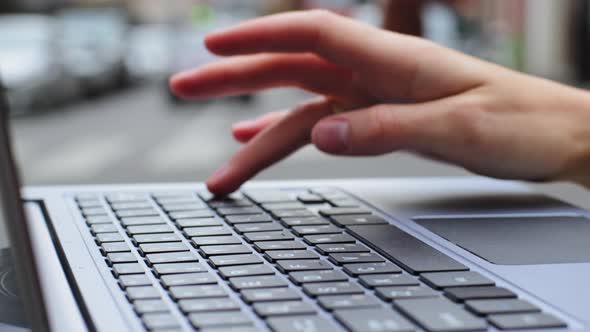 Closeup Female Hand of Caucasian User Typing Unrecognizable on Laptop Use Keyboard Outdoors Girl