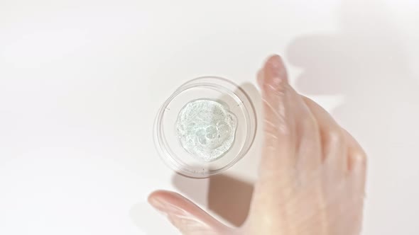 Petri Dishes with Cosmetics Samples on a White Background