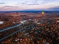 Aerial view of colorful hot air balloon is flying at sunset over the town in autumn season - PhotoDune Item for Sale