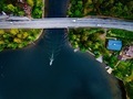 Aerial view of the bridge with a boat passing under it. Blue lake with summer houses in Finland. - PhotoDune Item for Sale