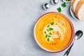 Carrot and pumpkin cream soup with parsley on gray stone background. - PhotoDune Item for Sale