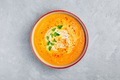 Carrot and pumpkin cream soup with parsley on gray stone background. - PhotoDune Item for Sale