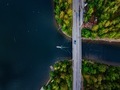 Aerial view of the bridge with a boat passing under it. Blue lake with summer houses in Finland. - PhotoDune Item for Sale