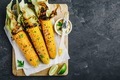Roasted or grilled sweet corn cobs with garlic butter and lime. - PhotoDune Item for Sale
